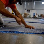 trimming the edges of a custom cut artificial grass logo