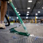 gluing a custom cut turf logo together